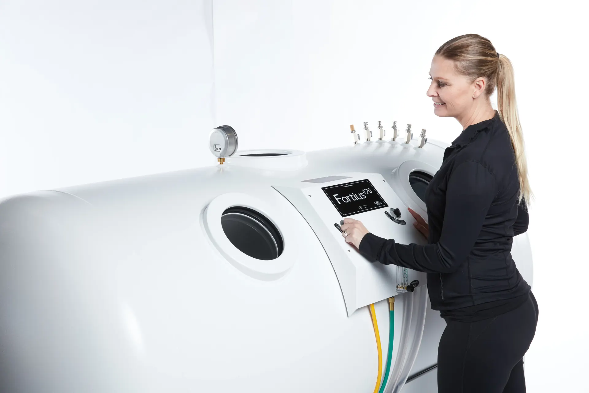 Clinic staff professionally operating an OxyHealth Fortius 420 hyperbaric chamber digital control panel
