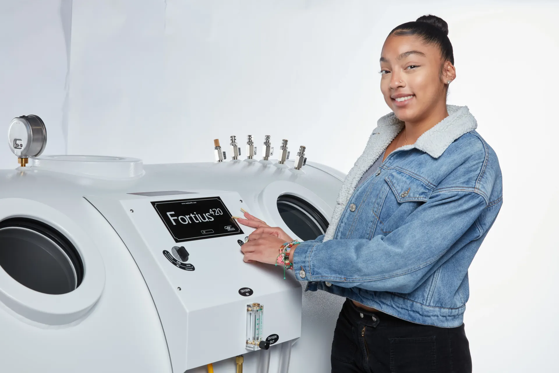 Woman at the control panel of an OxyHealth Fortius 420 hyperbaric chamber