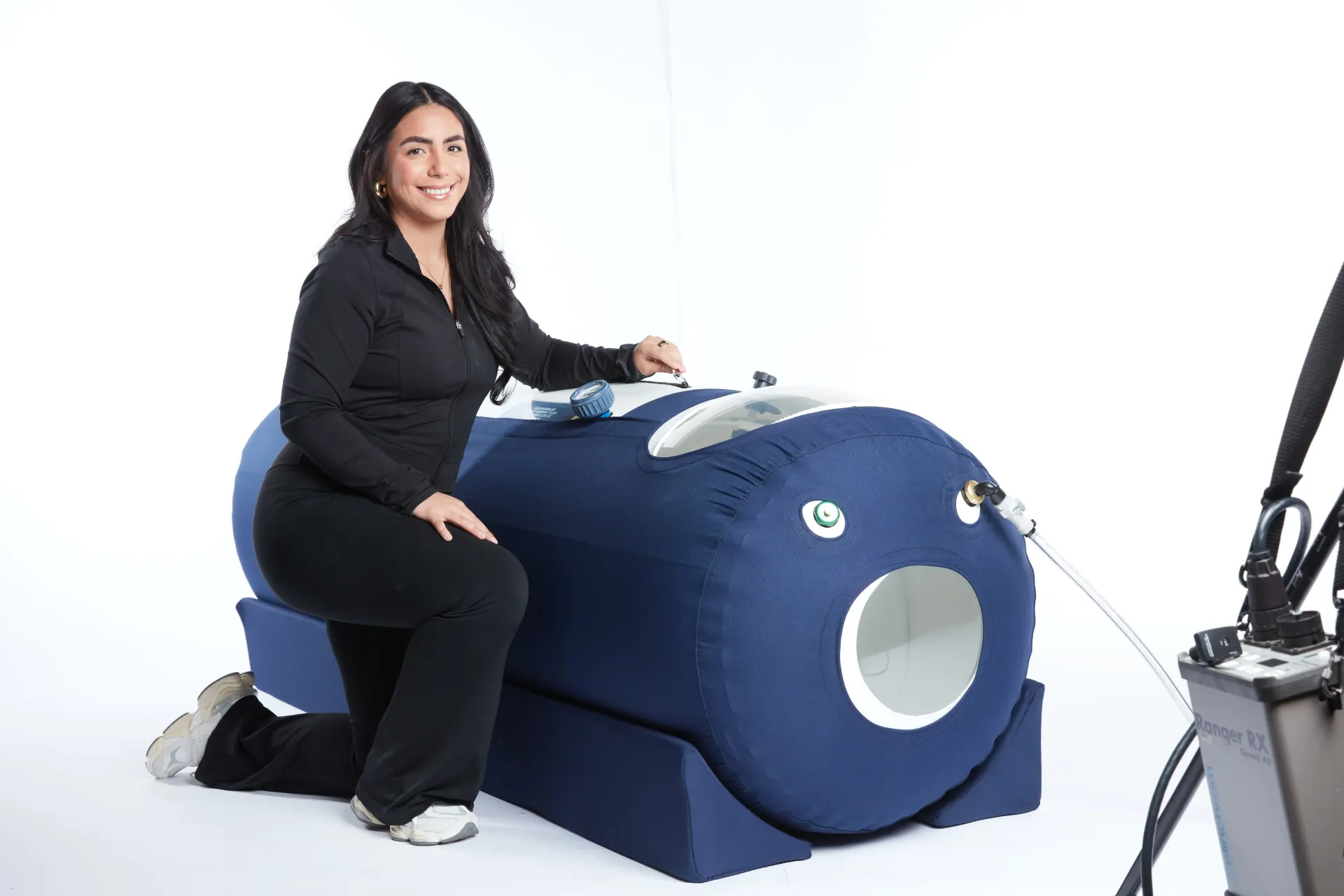 Woman using OxyHealth Respiro 270 hyperbaric chamber from alternate angle showing ease of use