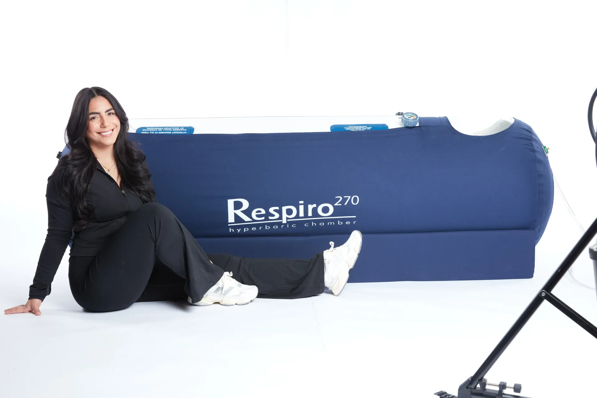 Woman operating OxyHealth Respiro 270 hyperbaric chamber controls