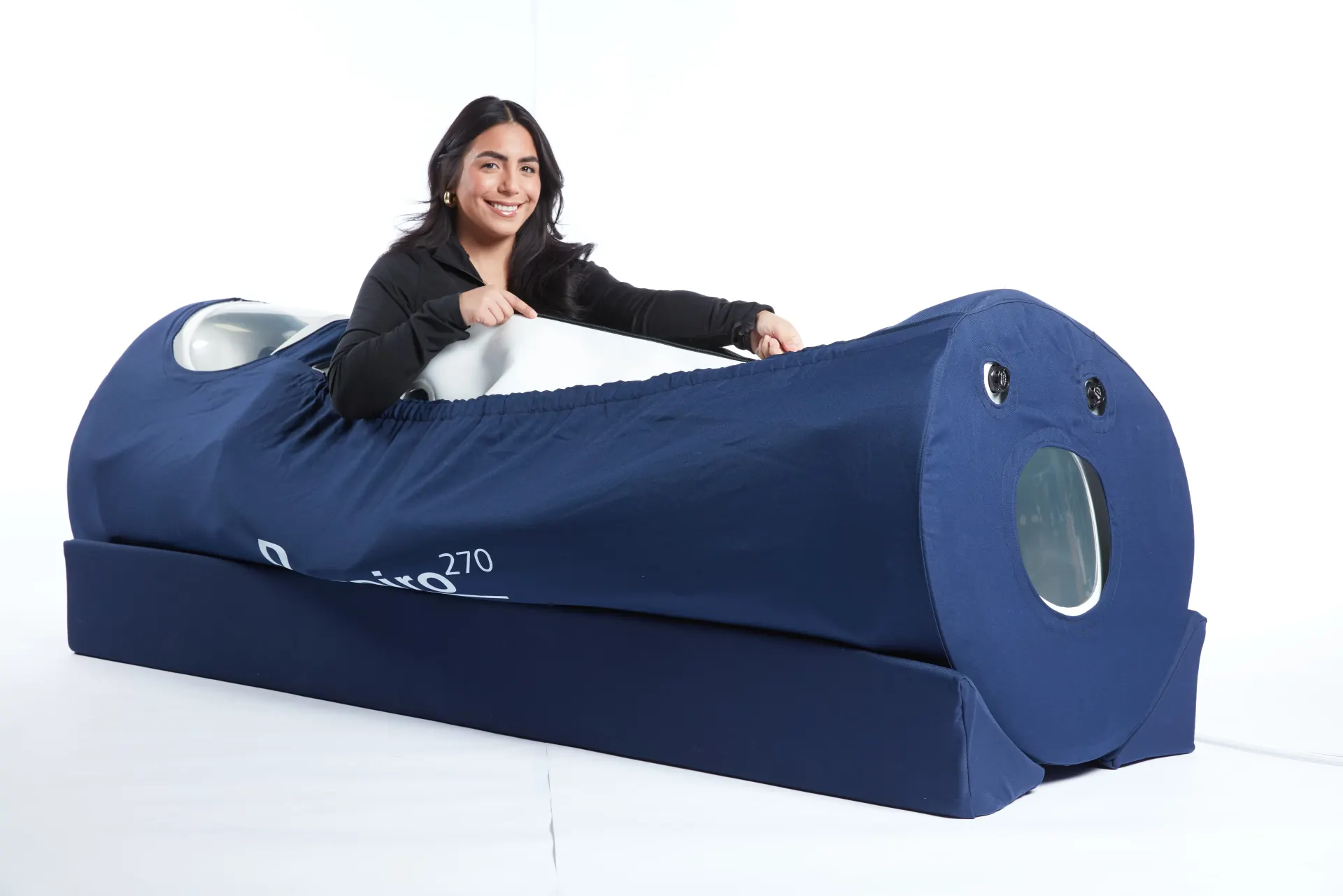 Woman with OxyHealth Respiro 270 portable hyperbaric chamber showing full product with branding