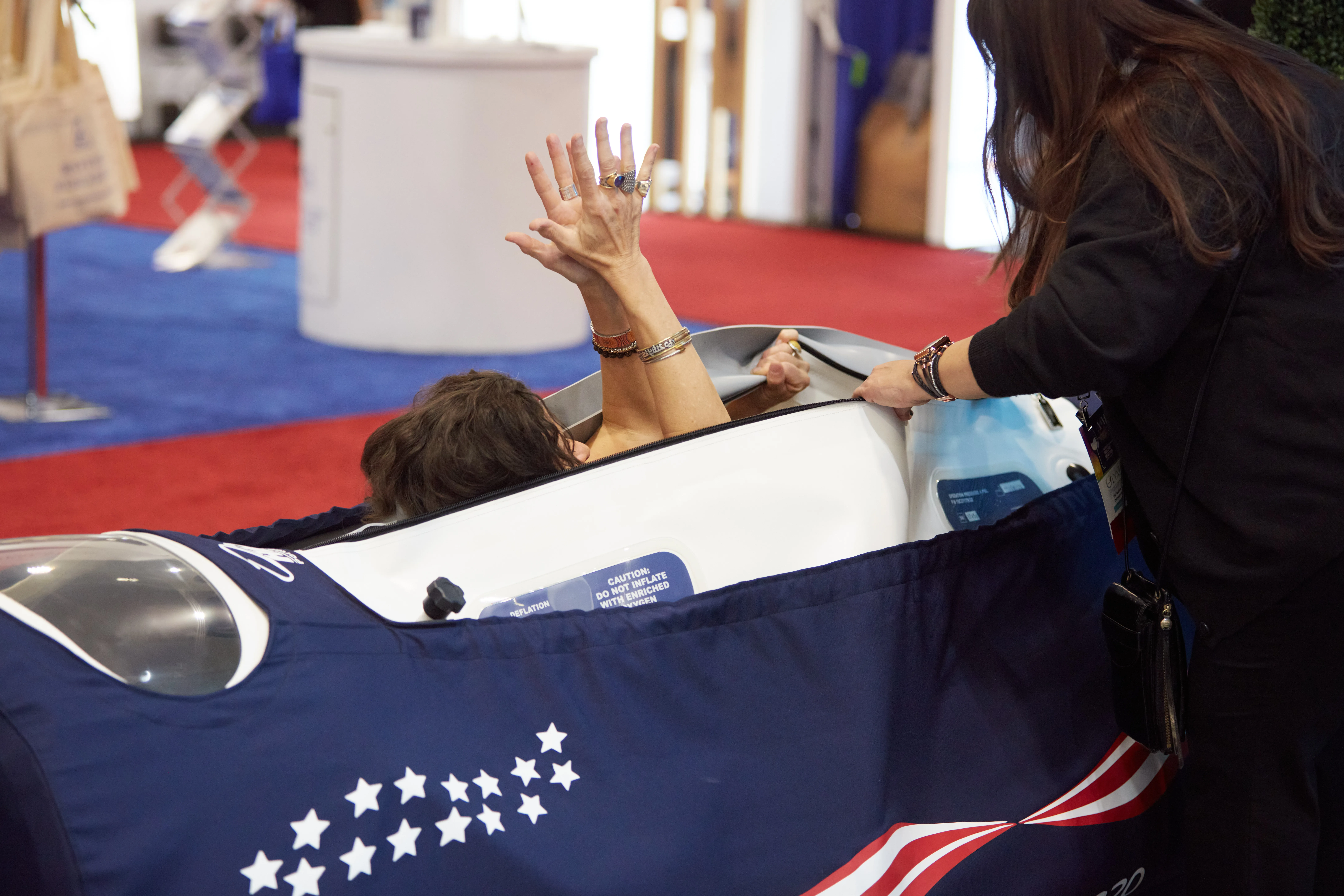 OxyHealth team demonstrating hyperbaric oxygen therapy technology at A4M longevity event